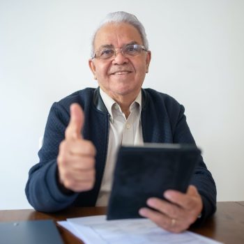 Man in Black Jacket Holding Black Tablet and Showing Thumb Up